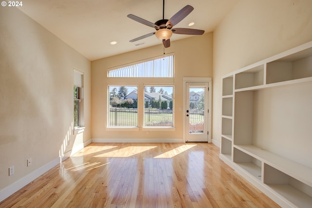 interior space featuring high vaulted ceiling, light hardwood / wood-style flooring, and ceiling fan