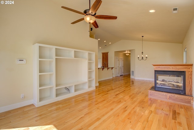 unfurnished living room with a multi sided fireplace, ceiling fan with notable chandelier, light hardwood / wood-style floors, and lofted ceiling