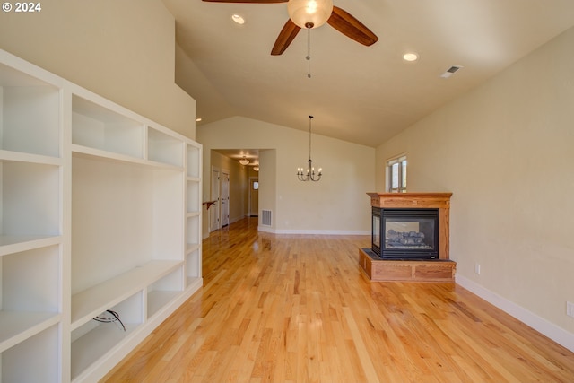 unfurnished living room featuring built in shelves, ceiling fan with notable chandelier, a multi sided fireplace, light hardwood / wood-style floors, and lofted ceiling