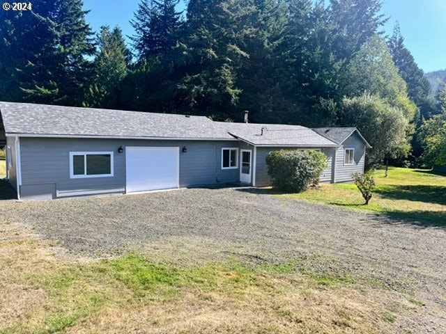 view of front of house with a garage and a front lawn