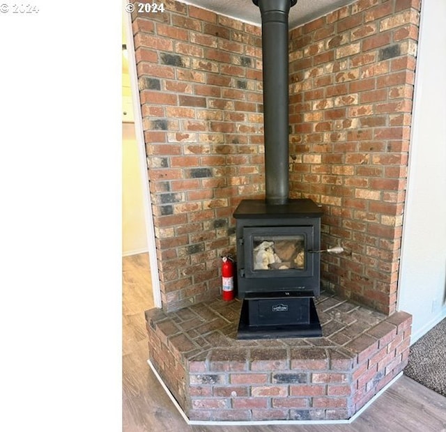 interior details featuring hardwood / wood-style flooring and a wood stove