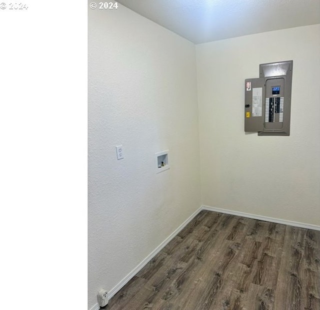 laundry room featuring electric panel, hookup for a washing machine, and dark wood-type flooring