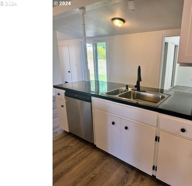 kitchen with dark hardwood / wood-style flooring, stainless steel dishwasher, a textured ceiling, sink, and white cabinets