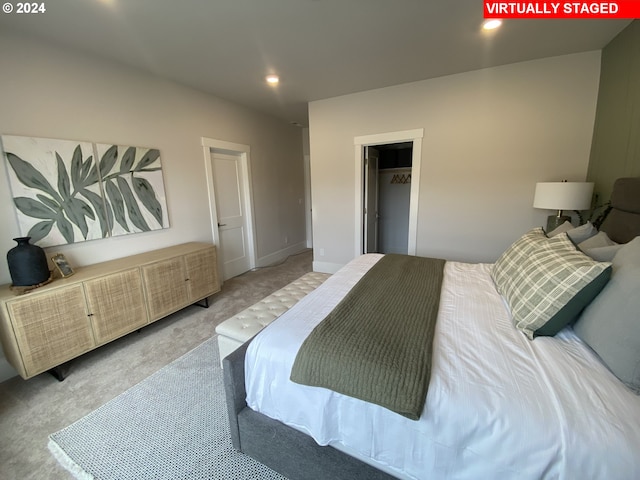 carpeted bedroom with a spacious closet and a closet