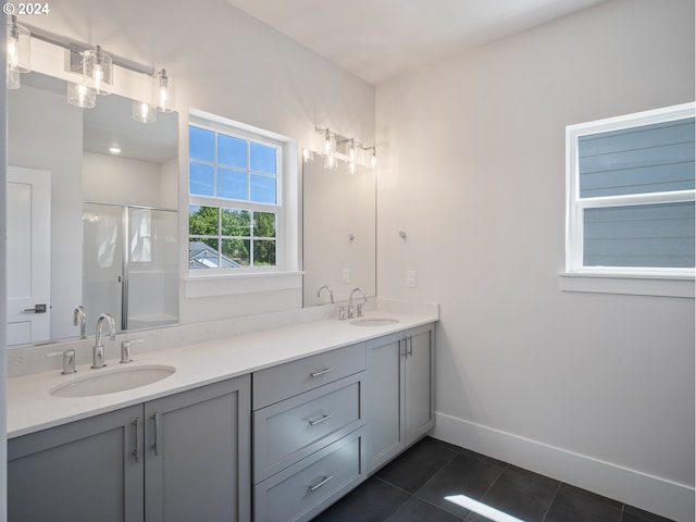 bathroom featuring vanity, an enclosed shower, and tile patterned floors