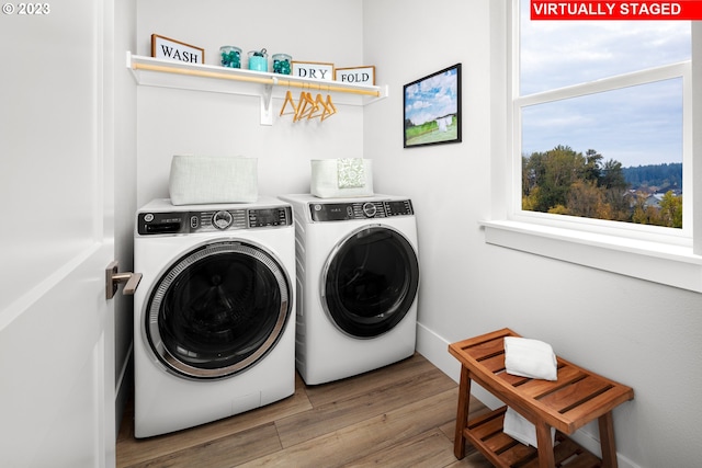 laundry area featuring wood-type flooring and washer and clothes dryer