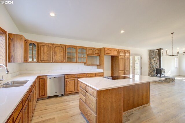 1381 Echo Dr, Roseburg, OR 97470 - kitchen with stainless steel dishwasher, a sink, a wood stove, brown cabinets, and light wood finished floors