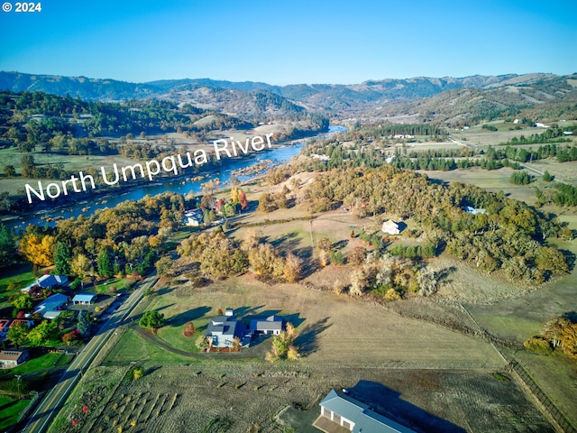 aerial view featuring a water and mountain view