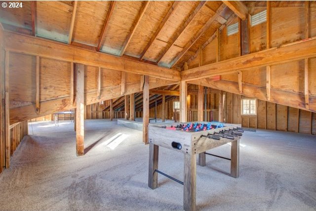 game room with lofted ceiling and carpet flooring