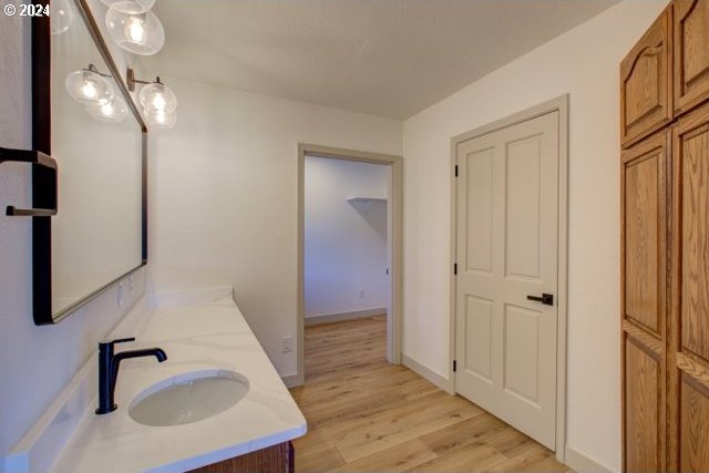 1381 Echo Dr, Roseburg, OR 97470 - bathroom with wood finished floors, double vanity, and baseboards