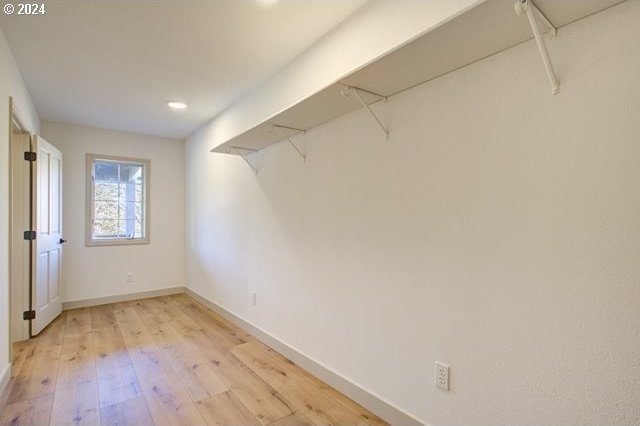 spacious closet with light hardwood / wood-style flooring