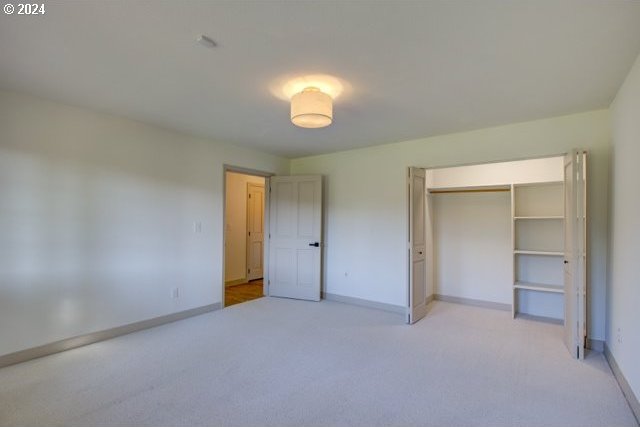 1381 Echo Dr, Roseburg, OR 97470 - unfurnished bedroom with light carpet, baseboards, and a closet