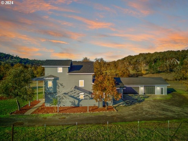 back house at dusk with a yard