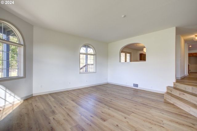 1381 Echo Dr, Roseburg, OR 97470 - unfurnished room featuring light wood-style flooring, baseboards, stairway, and arched walkways