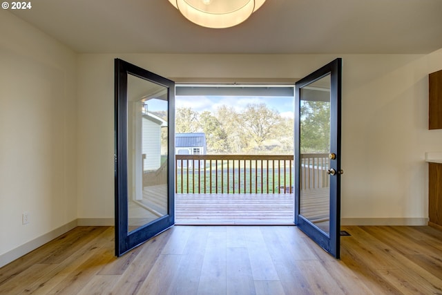 doorway to outside featuring french doors and light hardwood / wood-style floors