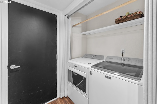 clothes washing area featuring washing machine and dryer and dark wood-style floors