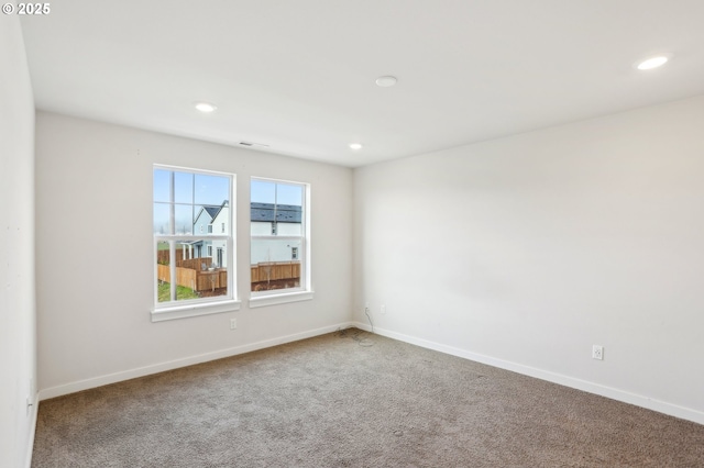 unfurnished room featuring carpet flooring