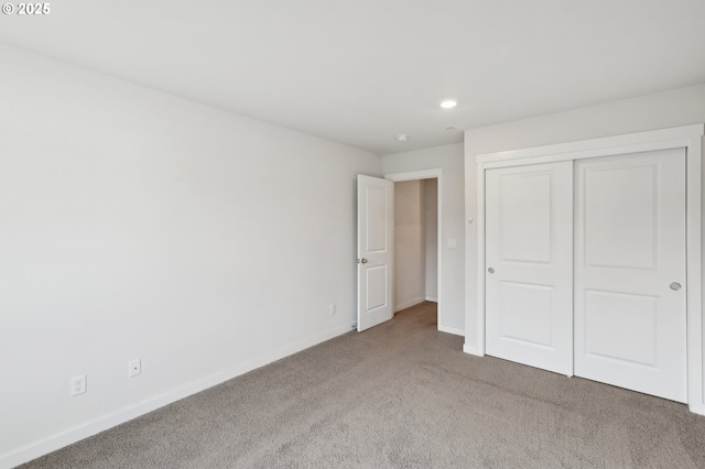 unfurnished bedroom with a closet and carpet