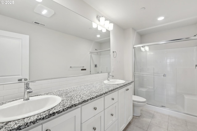 bathroom with toilet, a shower with door, vanity, and decorative backsplash