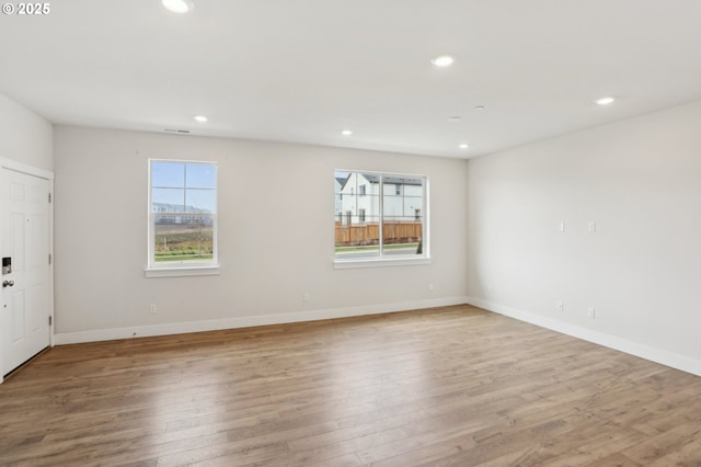 empty room featuring light hardwood / wood-style floors and a healthy amount of sunlight