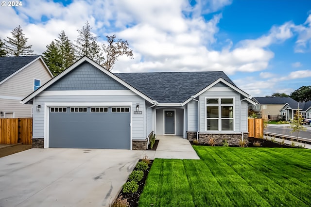 view of front of home with a garage and a front lawn