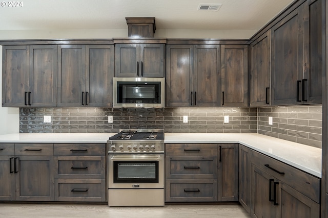 kitchen with backsplash, dark brown cabinetry, and stainless steel appliances