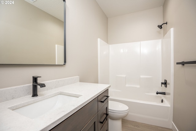 full bathroom featuring wood-type flooring, vanity, toilet, and shower / washtub combination