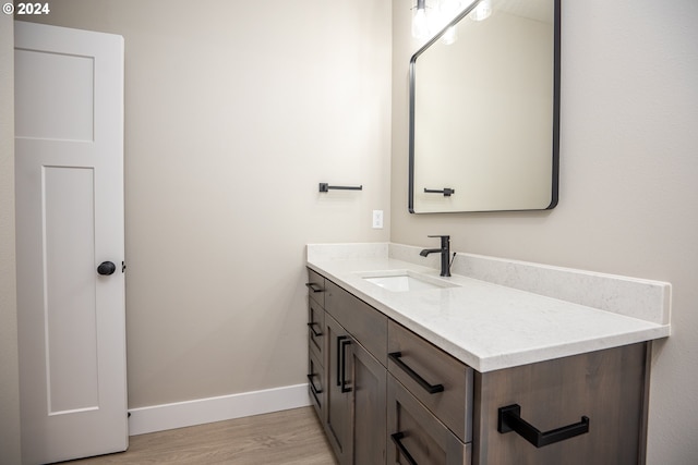 bathroom with vanity and wood-type flooring