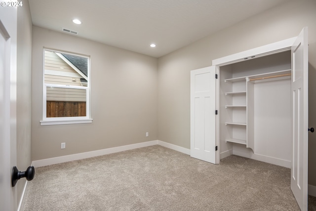 unfurnished bedroom with carpet flooring and a closet