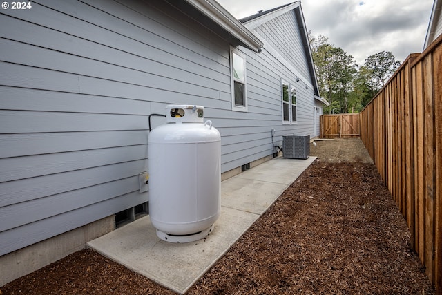 view of side of property featuring cooling unit and a patio