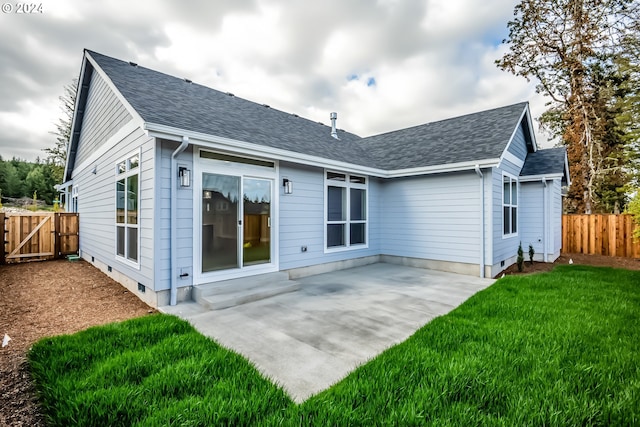 rear view of house featuring a patio and a lawn