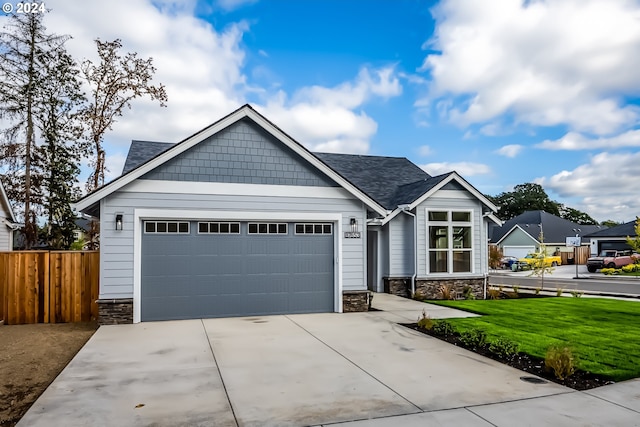 craftsman inspired home with a front yard and a garage