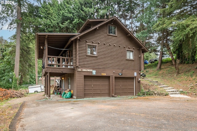 view of side of home featuring a garage and a deck