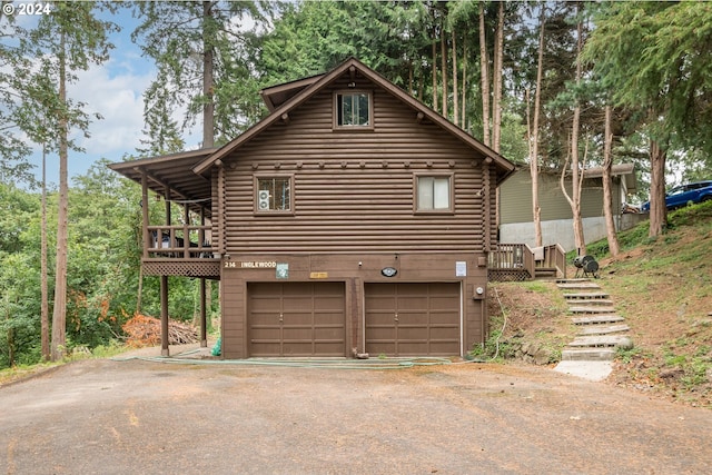 view of side of home featuring a garage and a deck