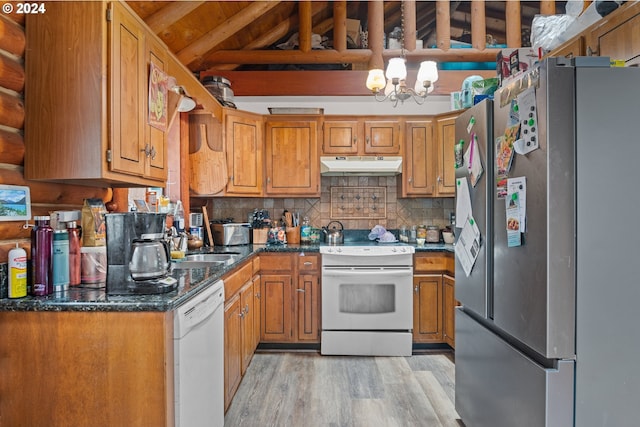 kitchen with a notable chandelier, dark stone countertops, light hardwood / wood-style floors, white appliances, and decorative backsplash