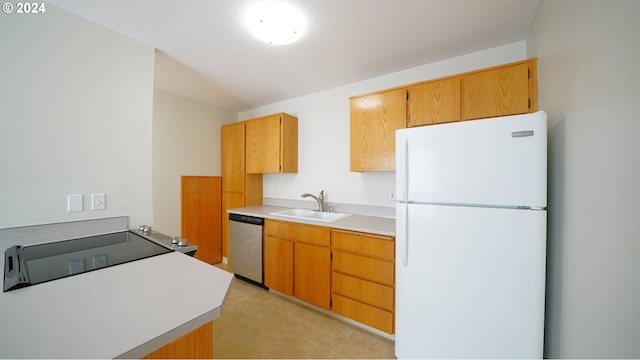 kitchen featuring stainless steel dishwasher, sink, and white refrigerator