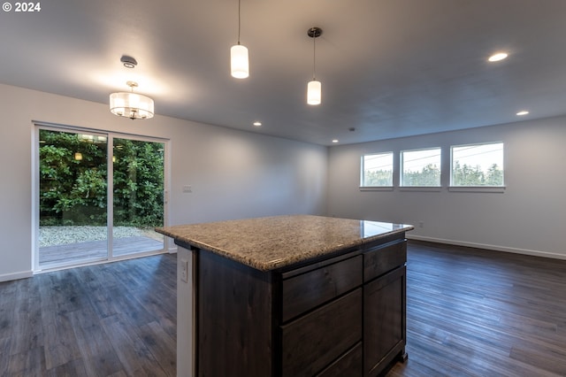 kitchen with a kitchen island, dark brown cabinetry, dark hardwood / wood-style floors, and hanging light fixtures