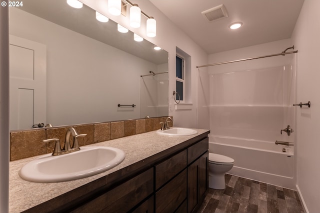 full bathroom with hardwood / wood-style flooring, vanity, bathtub / shower combination, and toilet