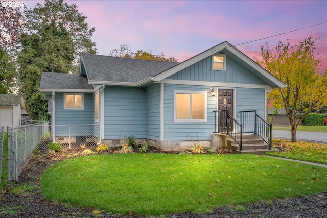 bungalow-style house with a lawn