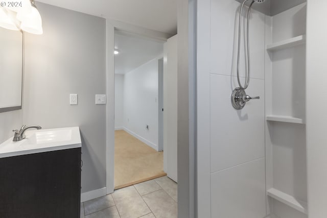 bathroom featuring walk in shower, vanity, and tile patterned flooring