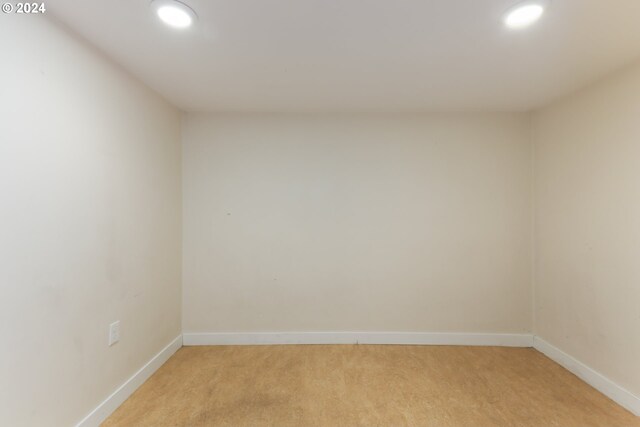 empty room featuring light colored carpet