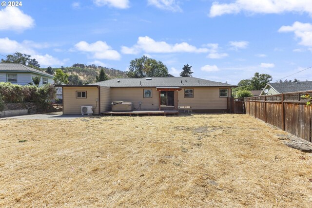 back of house featuring a patio area, a deck, and a lawn