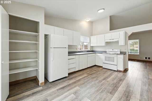 19875 SW Southview St, Beaverton, OR 97078 - kitchen with white appliances, high vaulted ceiling, light wood-type flooring, white cabinets, and under cabinet range hood