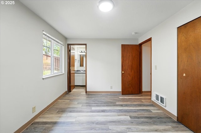 19875 SW Southview St, Beaverton, OR 97078 - unfurnished bedroom featuring wood finished floors, a closet, baseboards, and connected bathroom