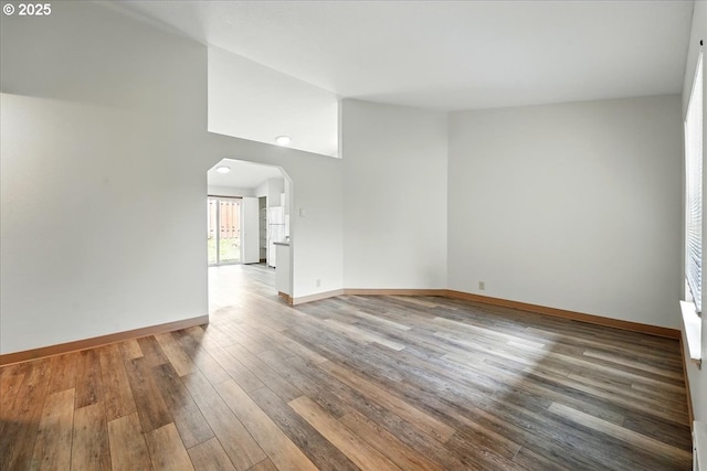 19875 SW Southview St, Beaverton, OR 97078 - unfurnished room featuring arched walkways, hardwood / wood-style flooring, baseboards, and vaulted ceiling