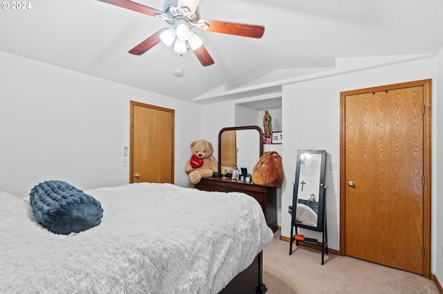 bedroom with ceiling fan, light carpet, and vaulted ceiling