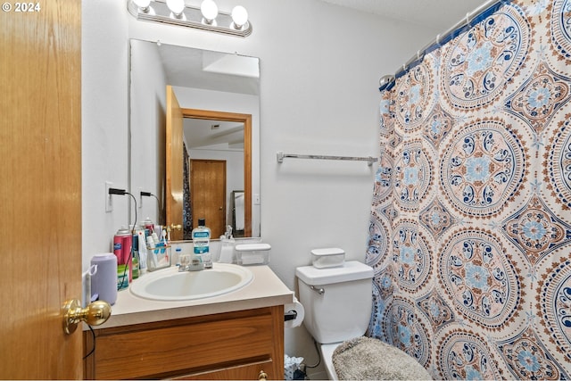 bathroom featuring vanity, toilet, and curtained shower