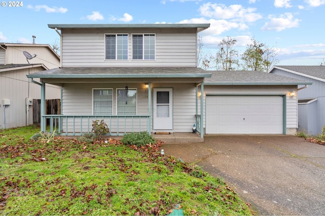 view of front property with a porch and a garage