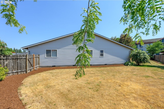 rear view of house with a lawn