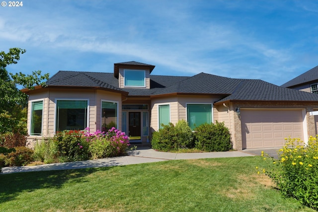 view of front of house featuring a front lawn and a garage